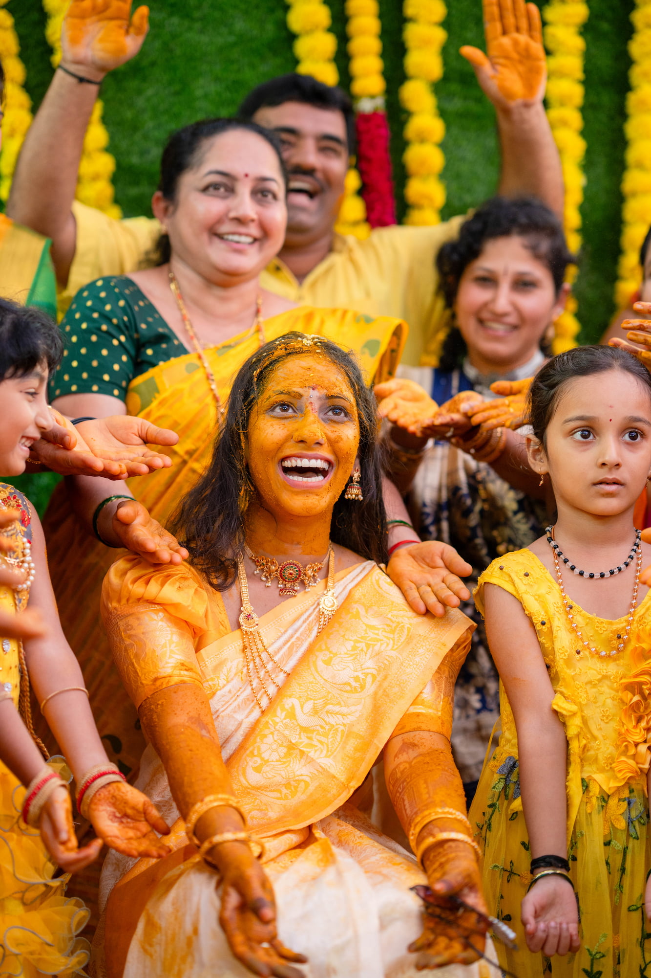 Candid photograph of a bride laughing with her family during a Sirsi wedding